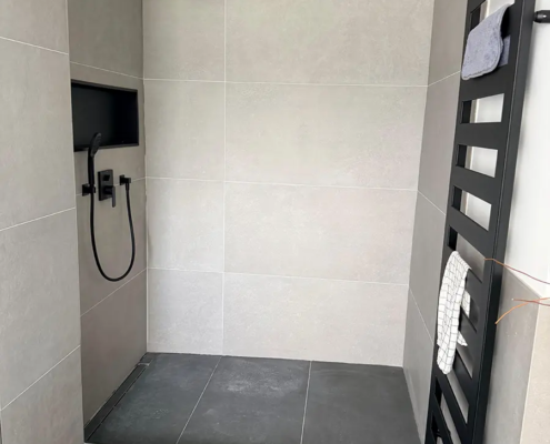 Bodengleiche Dusche mit Linienrinne und schwarzen Armaturen